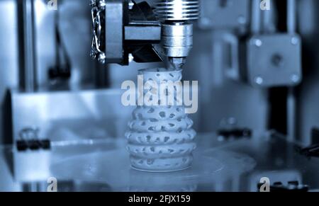 3d printer printing objects blue gray color form closeup. Stock Photo