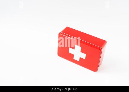 Red simplistic first aid box, white background, high key, horizontal format Stock Photo