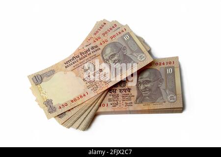 Stack of Indian currency notes of ten rupees isolated on a white background Stock Photo