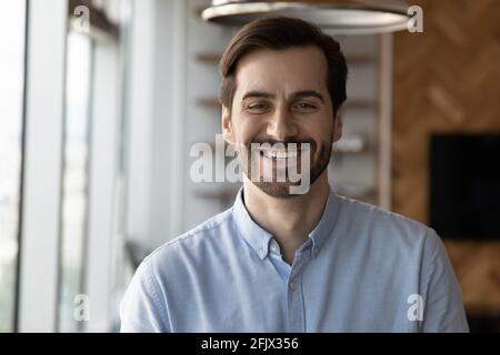 Headshot portrait of smiling man posing in office Stock Photo