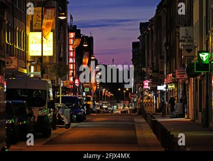 Cologne, Germany. 26th Apr, 2021. Severinsstrasse is empty in the evening during curfew. The number of new Corona infections per 100,000 inhabitants reported in seven days has again slightly increased in North Rhine-Westphalia. Credit: Oliver Berg/dpa/Alamy Live News Stock Photo