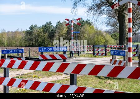 Unguarded railway crossing for cyclists and pedestrians only, guarded with gates Stock Photo