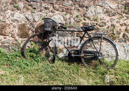 Bicycle and an old fortification wall in Galle, Sri Lanka Stock Photo