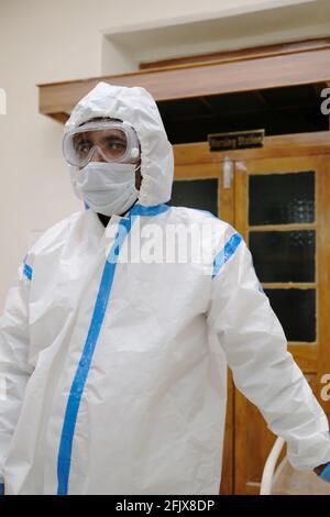 Vertical shot of a male doctor in a special protective costume during the COVID-19 pandemic Stock Photo