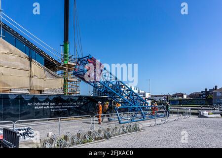 Workers manoeuvring equipment into place on a construction site in Hanover Quay in Dublin, Ireland. Stock Photo