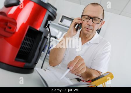 man repairing a coffee maker Stock Photo