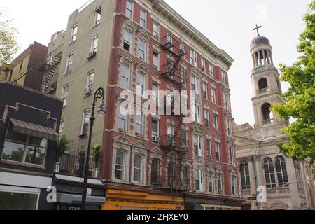 Facade of the late 19th-century multistory apartment building in the South Village neighborhood, at the corner of Bleecker and Carmine Streets, NYC Stock Photo