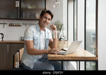 Portrait of smiling man work on laptop online Stock Photo