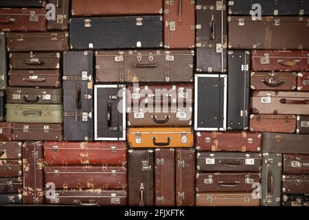 Number of old antique suitcases on wall background Stock Photo