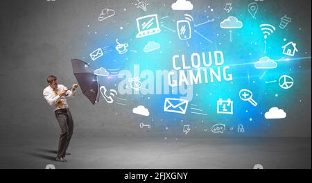 Businessman defending with umbrella, modern technology concept Stock Photo