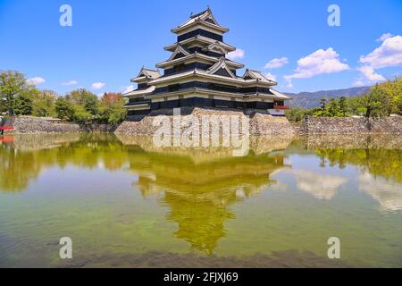 Matsumoto Castle, Fukashi Castle, Crow Castle,  water reflection and blue  sky. Matsumoto City, Nagano Prefecture, Japan. Stock Photo