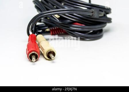 Two red and white audio RCA plugs isolated on a white background. Analog technology. Commonly used to carry audio and video signals Stock Photo