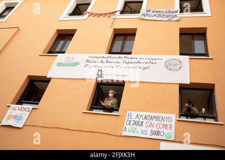 Madrid, Spain. 26th Apr, 2021. Demonstrators seen looking through a building window with posters on the building during the demonstration demand that the cultural centers of Madrid not be closed. Credit: SOPA Images Limited/Alamy Live News Stock Photo