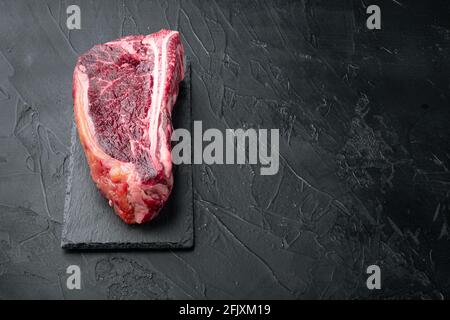 Raw fresh meat dry aged Club Steak set, on black stone background, with copy space for text Stock Photo