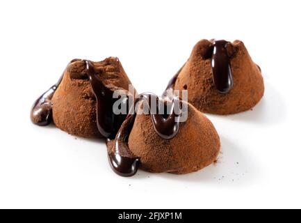 Chocolate truffles with chocolate sauce on a white background Stock Photo