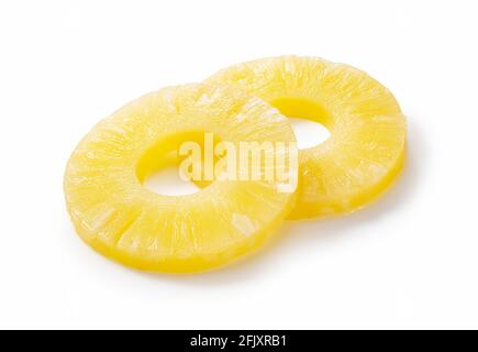 Pineapple slices placed on a white background. Contents of a can of pineapple. Stock Photo