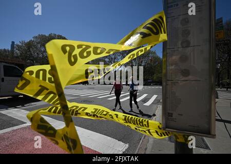 New York, USA. 26th Apr, 2021. People walk past yellow police tape on the corner of 5th Avenue and 79th street, set up after a suspicious package was reported near the entrance of the Metropolitan Museum of Art a few blocks away, New York, NY, April 26, 2021. Streets were reopened after the NYPD Bomb squad declared the all clear after inspecting what turned out to be a just a suitcase. (Photo by Anthony Behar/Sipa USA) Credit: Sipa USA/Alamy Live News Stock Photo