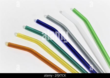 Colorful reusable glass straws on white background. An alternative replacement for classic disposable plastic drinking straw, great for the environment Stock Photo