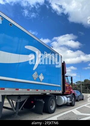 Amazon Prime logo on a delivery truck on the highway. Stock Photo