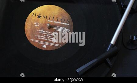 Close-up of Hamilton Original Broadway Cast Recording Vinyl Record LP disc on a record player. Stock Photo