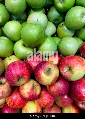 Fresh green and red apples on shelf. View from above Stock Photo