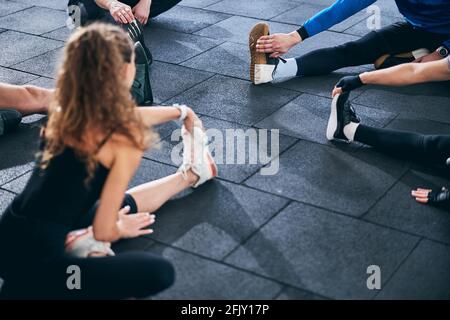 Five young people performing a stretching exercise Stock Photo