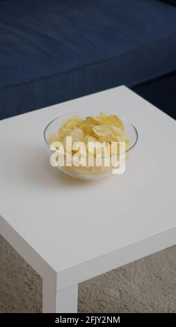 Front view of empty room with nobody in it prepared for night party. Living room having potato chips bowl on woden table, apartament is ready for friends gathering celebrating wekeend birthday Stock Photo