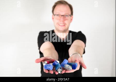 Man using an asthma spray inhaler Stock Photo