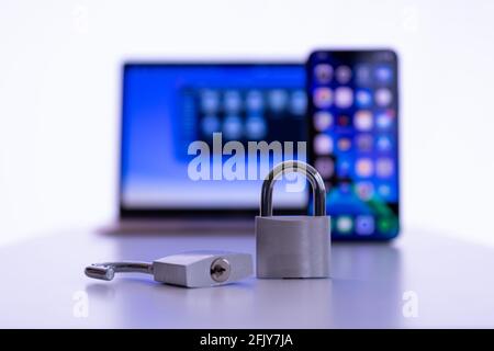 Privacy and data protection: Laptop and smartphone with padlock in foreground Stock Photo