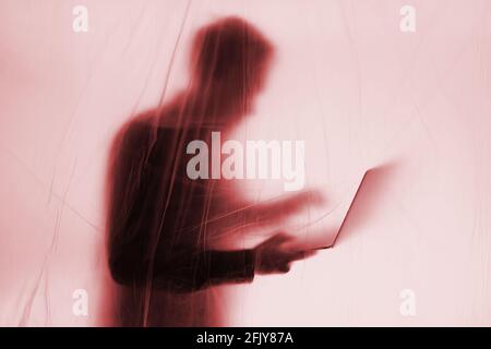 Anonymous Hacker commits cyber crime Stock Photo