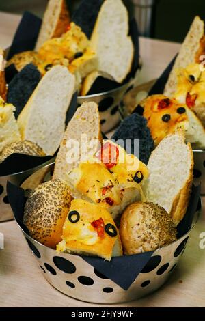 assorted fresh breads in a metal basket Stock Photo