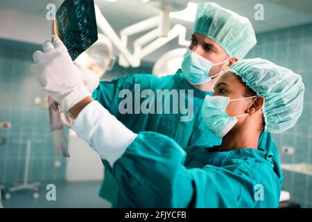 Exhausted surgeons at the emergency room as a sign of stress and overwork Stock Photo