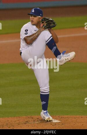 Starting pitcher Julio Urias #7 of the Los Angeles Dodgers warms up in the  bullpen prior to a baseball game between the Los Angeles Dodgers…