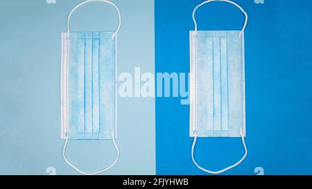 Two medical masks on two different blue backgrounds. Stock Photo