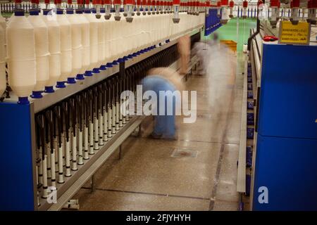 Making cotton thread from raw cotton in Textile Spinning unit. Stock Photo