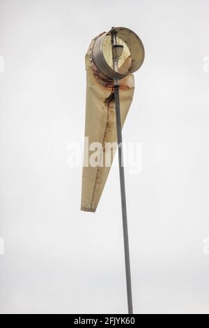 Faded Limp WindSock with no Wind against a White Sky, Te Anau, South Island, New Zealand Stock Photo