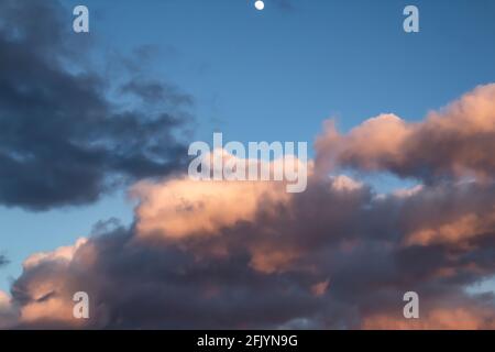 A beautiful dark clouds in the blue sky with moon against background Stock Photo