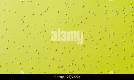 Festive frame made of colorful pastel sprinkles on a yellow background, copy space. Sprinkle sugar with with stars, decoration for cake and bakery pro Stock Photo