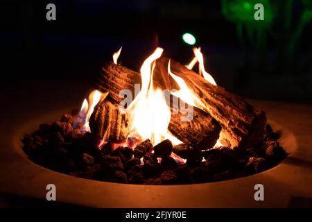 Roasting marshmallow over a gas fire while glamping Stock Photo