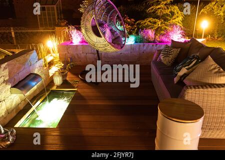 Smart Ambient garden lighting on a bangkirai terrace Stock Photo