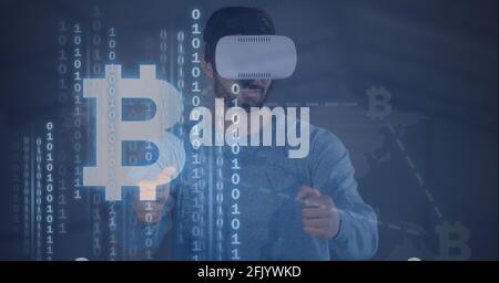 Composition of binary coding bitcoin symbols over man wearing vr headset touching screen Stock Photo