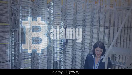 Composition of bitcoin symbol and binary coding over woman and computer servers Stock Photo