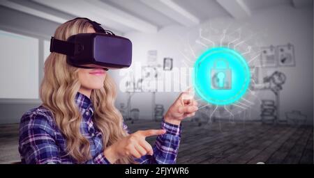 Composition of online security padlock icon over woman wearing vr headset touching screen Stock Photo