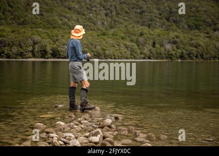 Tramper Fishing in the Mavora Lakes, near Mossburn, South Island, New Zealand Stock Photo