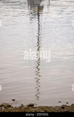 Yacht Mast Reflected in the Lake Ripples, Te Anau, South Island New Zealand Stock Photo