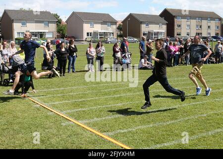 Muirhead Primary School Sports Day The Dads rush to the line Stock Photo