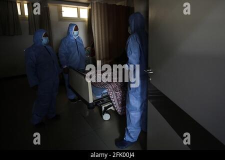 Cairo, Egypt. 26th Apr, 2021. Nurses check on a Covid-19 patient, inside the Intensive Care Unit (ICU) of Heliopolis hospital, which is currently serving as an isolation hospital for Coronavirus (COVID-19) patients. Credit: Fadel Dawood/dpa/Alamy Live News Stock Photo