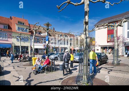 Bad Dürkheim, Germany - April 2021: Town square called 'Statdplatz' in old historic city center of spa town Bad Dürkheim with many people on sunny day Stock Photo