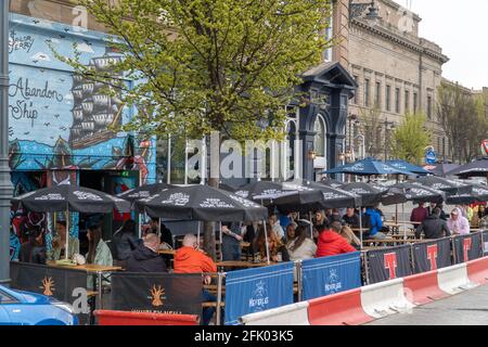 Dundee, Tayside, Scotland 26th of Apr 2021: Pubs with beer gardens open throughout Dundee city centre, as the scottish government relax the lock down restrictions, which see business opening up, and some normality returning to people lives. Stock Photo