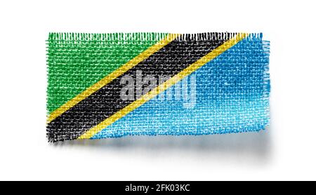 Tanzania flag on a piece of cloth on a white background Stock Photo